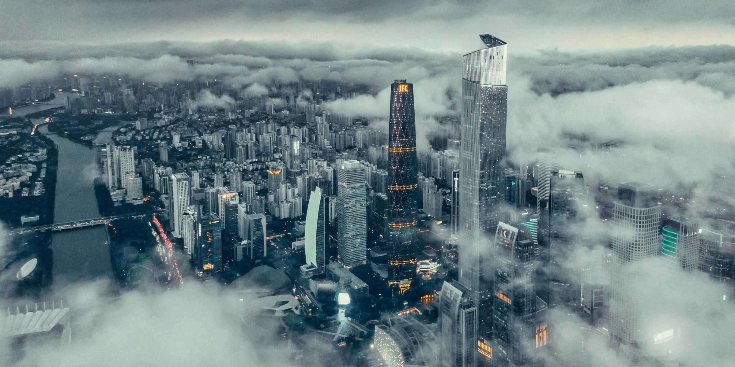Drone Shot Showcasing a City with Clouds in the frame