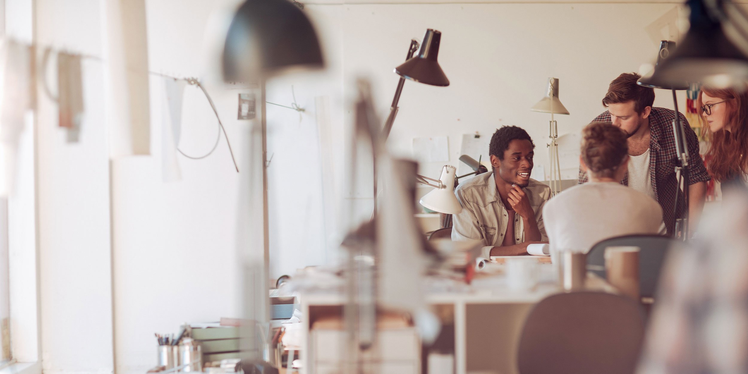 Transform Your Culture - group of employees meeting at a desk