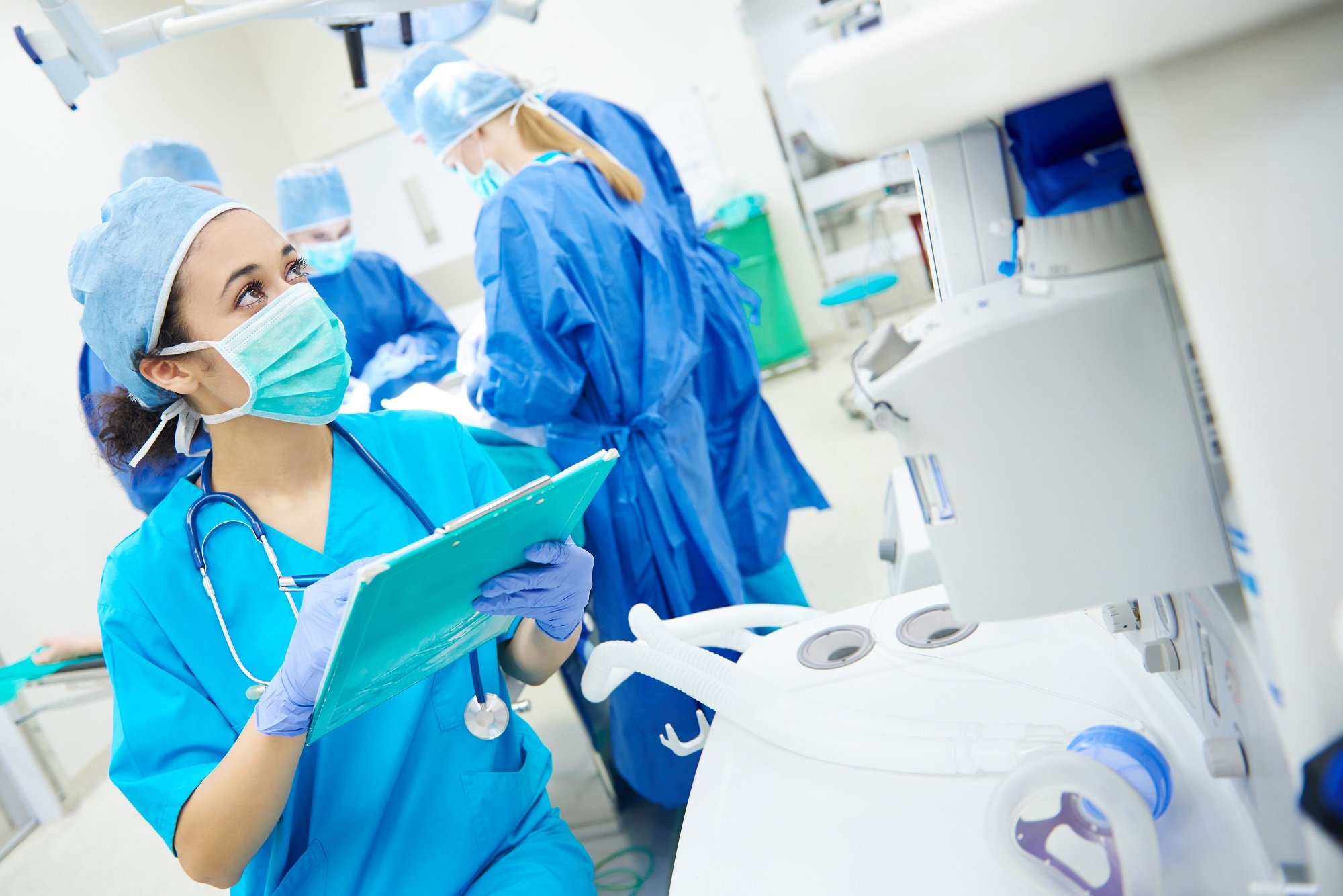 Nurse taking notes from computer